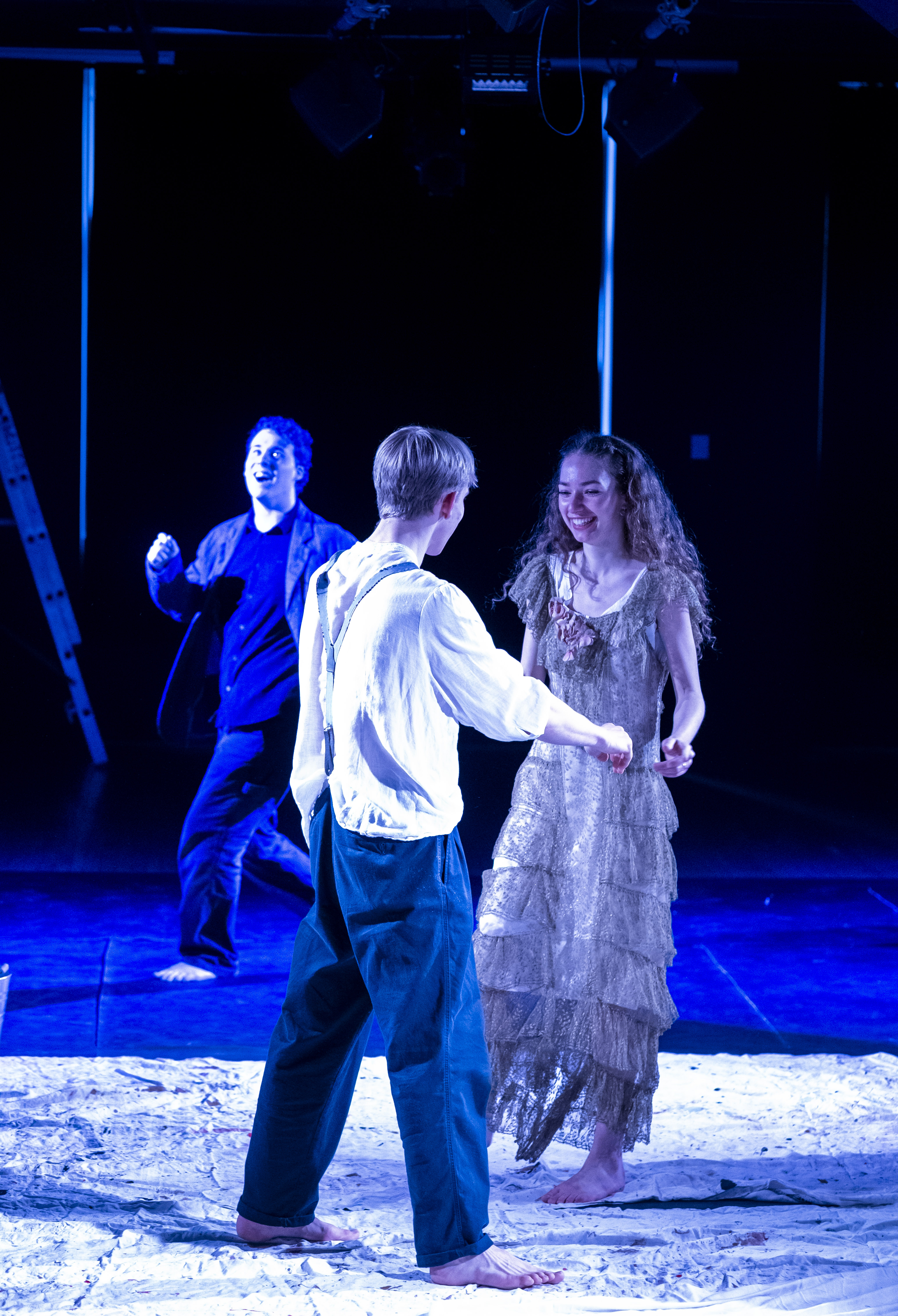 Orpheus reaching towards Eurydice in a gold gown, a third figure behind them.