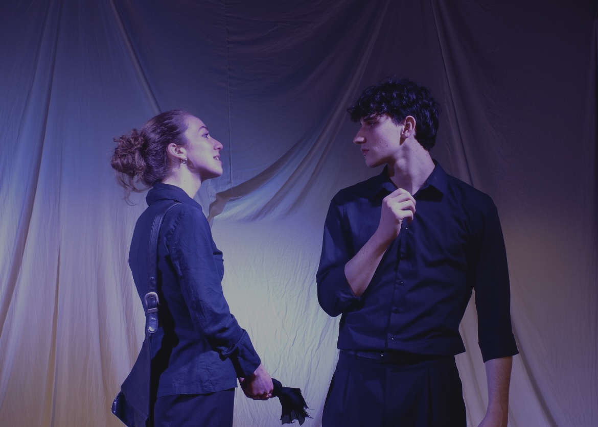 The Duchess and Antonio face each other in warm light, a glove between them.